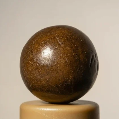 Brown sphere with a smooth surface and subtle reflections.