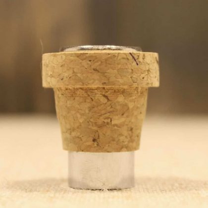 Cork and metal bottle cap, isolated on a neutral background, showcasing the texture and materials us.